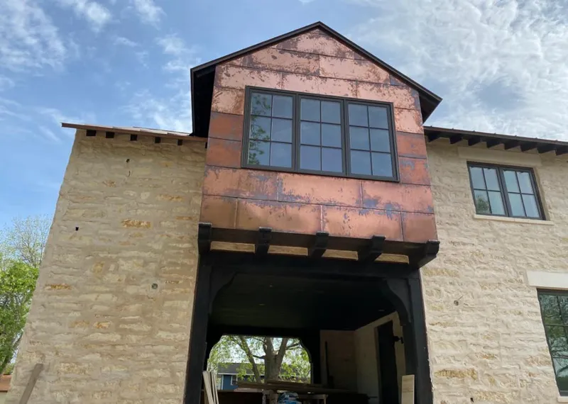 Copper metal panel facade on a stone building for Skylight Installation in Sebastopol